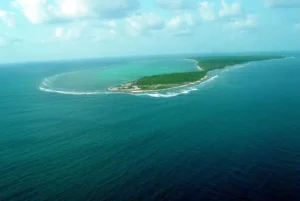 Aerial view of Kavaratti Island surrounded by blue ocean, ideal for traveling, exploring, and tour planning.