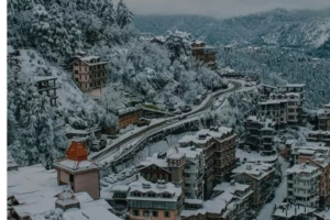 Snow-covered hill town with winding roads, perfect for traveling, exploring, and tour planning.